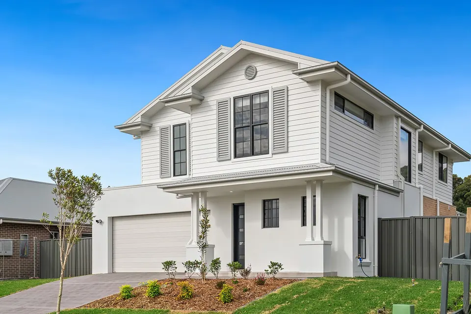 A finished two-storey G Dev home with a white and grey Hamptons-style front.